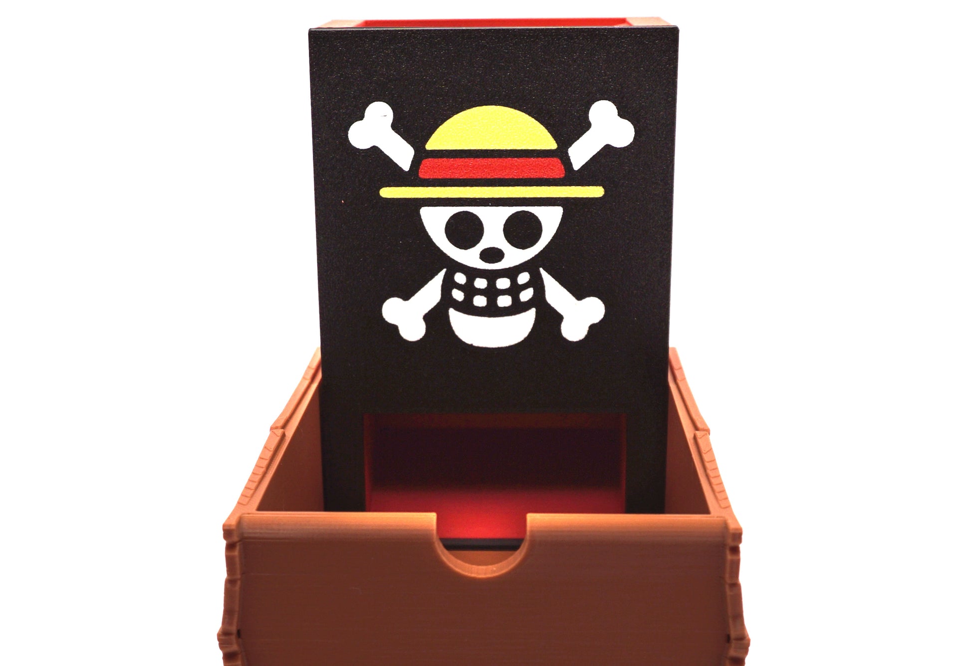 Front view of the One Piece Dice Tower showing the Strawhats jolly roger and the notch in the dice tray to open the dice tower when it's collapsed