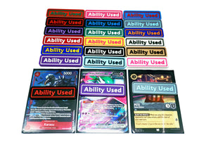 Ability Used markers for TCG and Tabletop gameplay. Shown in a variety of colors against a white background. Three of which are on top of cards from Pokemon, One Piece, and Lorcana