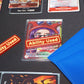 A Red and Yellow Ability User Marker sits on top of the Belo Betty leader alt art card with the hand face down next to it, all on top of a black playmat