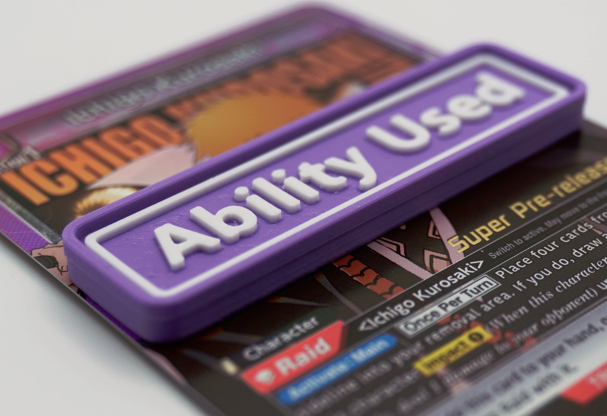 A purple Ability Used marker with white text shown on top of an Ichigo card from the Union Arena TCG.