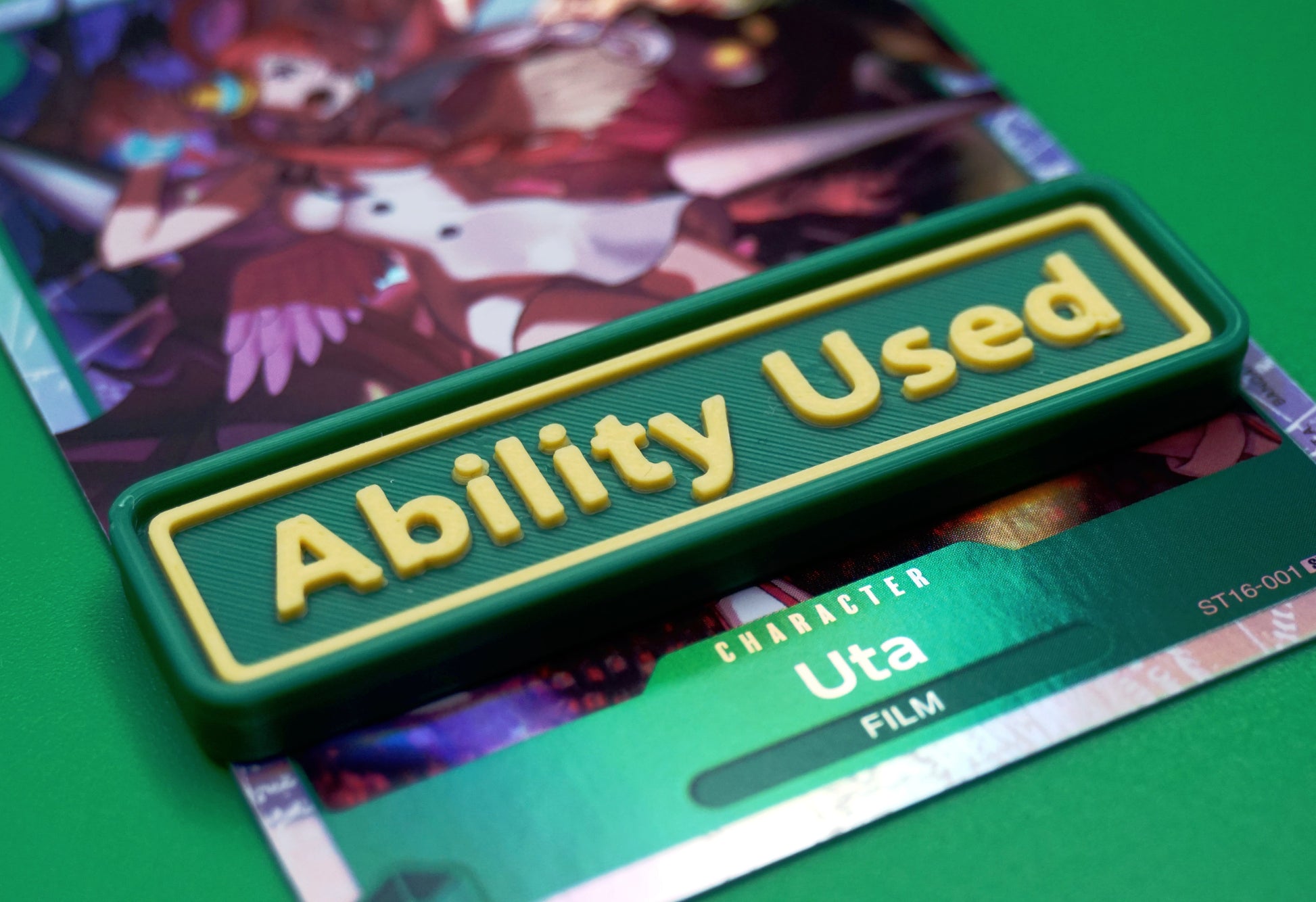 A green Ability Used marker with yellow text shown on top of a Uta card from the One Piece TCG.