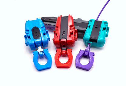 Beyblade X Slip Grip for string and winder launchers, showing the Sky blue, Cherry, and Purple color options on their respective color matching launchers.