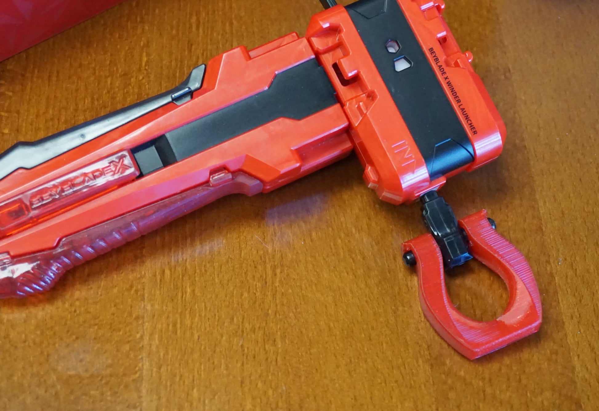 The Slip Grip in red attached to the black ripcord in the red launcher and red handle