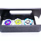 The Garage Style deck box with handle in black with white door and tray with Shark Scale, Hover Wyvern, and Emperor Blast against a white background