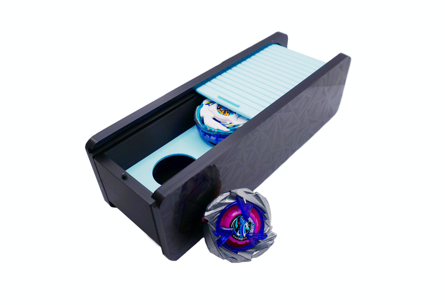 The Beyblade X Garage Door style deckbox from Momo's Models shown in black with glacier color scheme. Inside is the Pegasus Blast beyblade while outside sits the Shark Scale beyblade, with everything against a white background