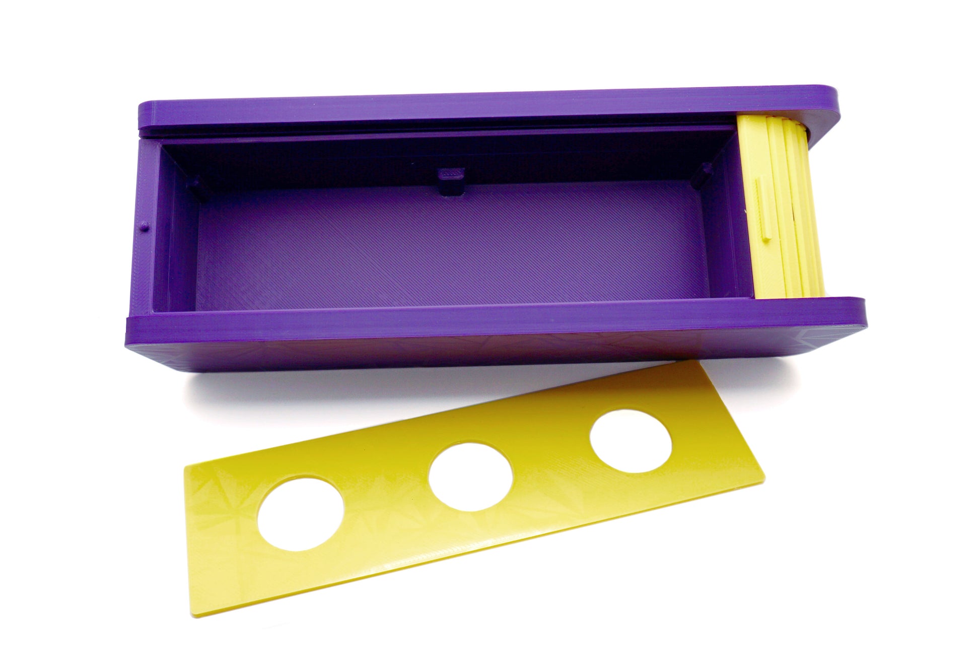 The Beyblade X Garage Door style deckbox from Momo's Models shown in purple and yellow color scheme. The inside panel is taken out to show the inside storage space. With everything against a white background