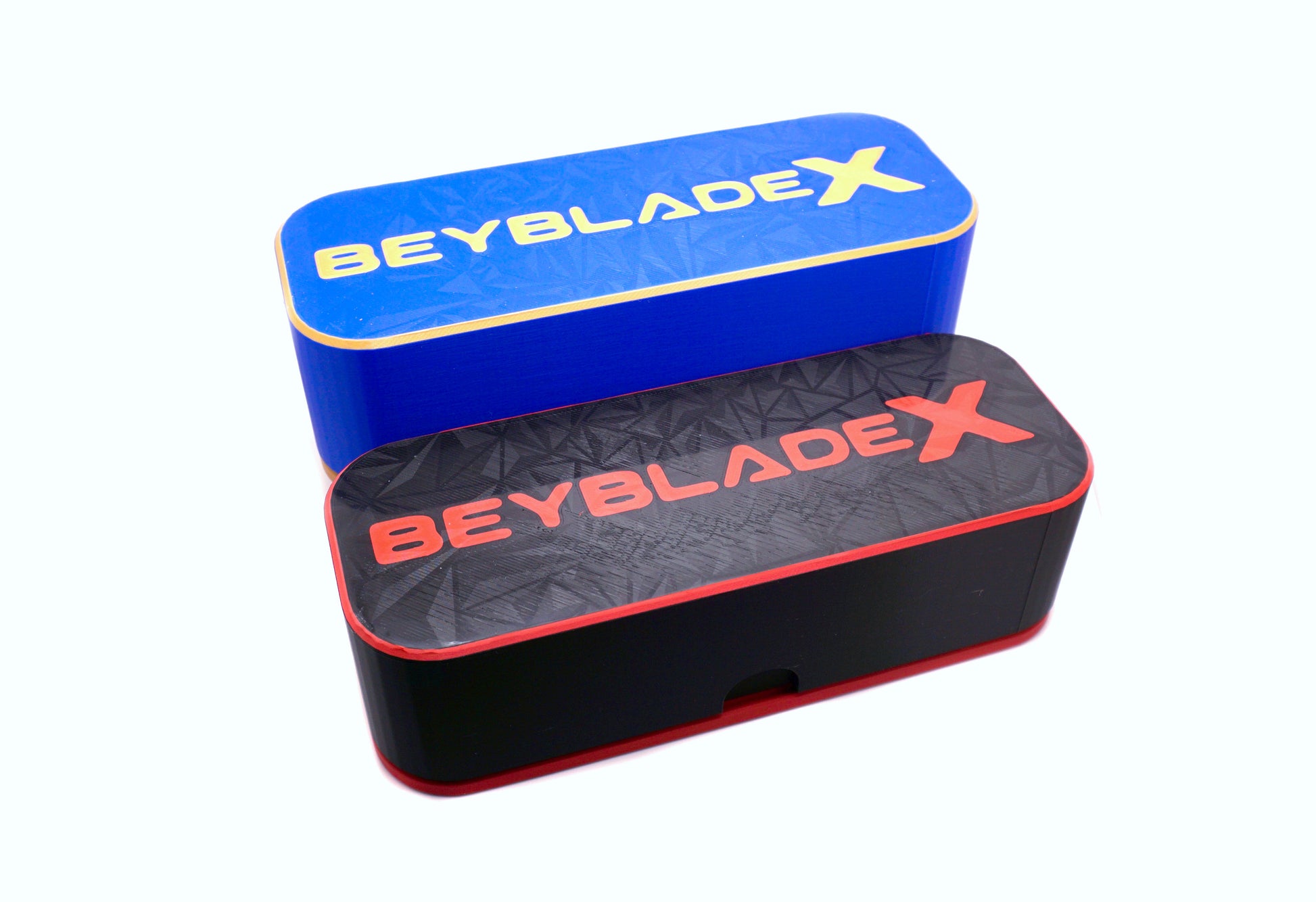 Two Beyblade X Deckboxes from Momo's Models shown in the blue/gold and black/red color combinations against a white background