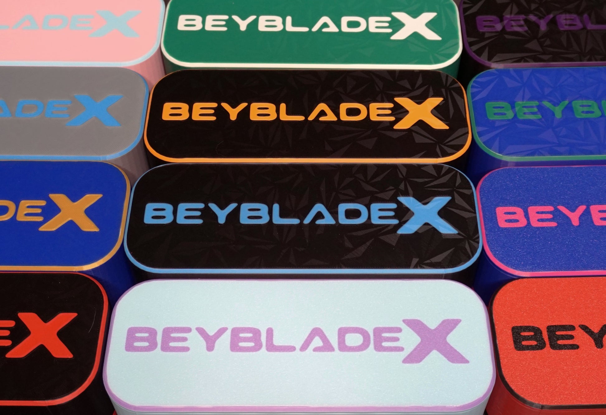 The Beyblade X Deckbox from Momo's Models shown in various color combinations that can be picked.