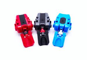 The Thumb Tab or thicc boi launcher attachment on 3 different string launchers for Beyblade X, colors shown are red, black, and sky blue against a white background