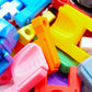 A bunch of different colored Thumb Tabs in a pile with some string launchers