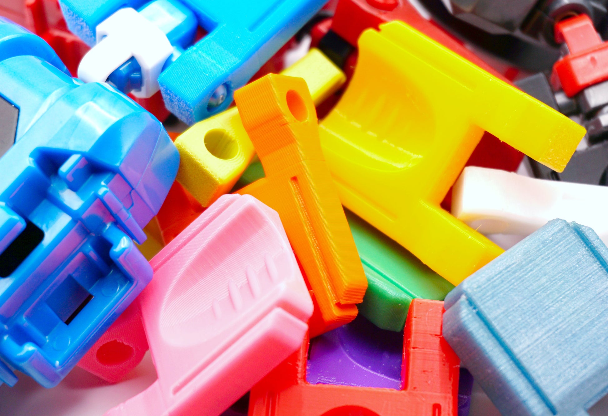 A bunch of different colored Thumb Tabs in a pile with some string launchers