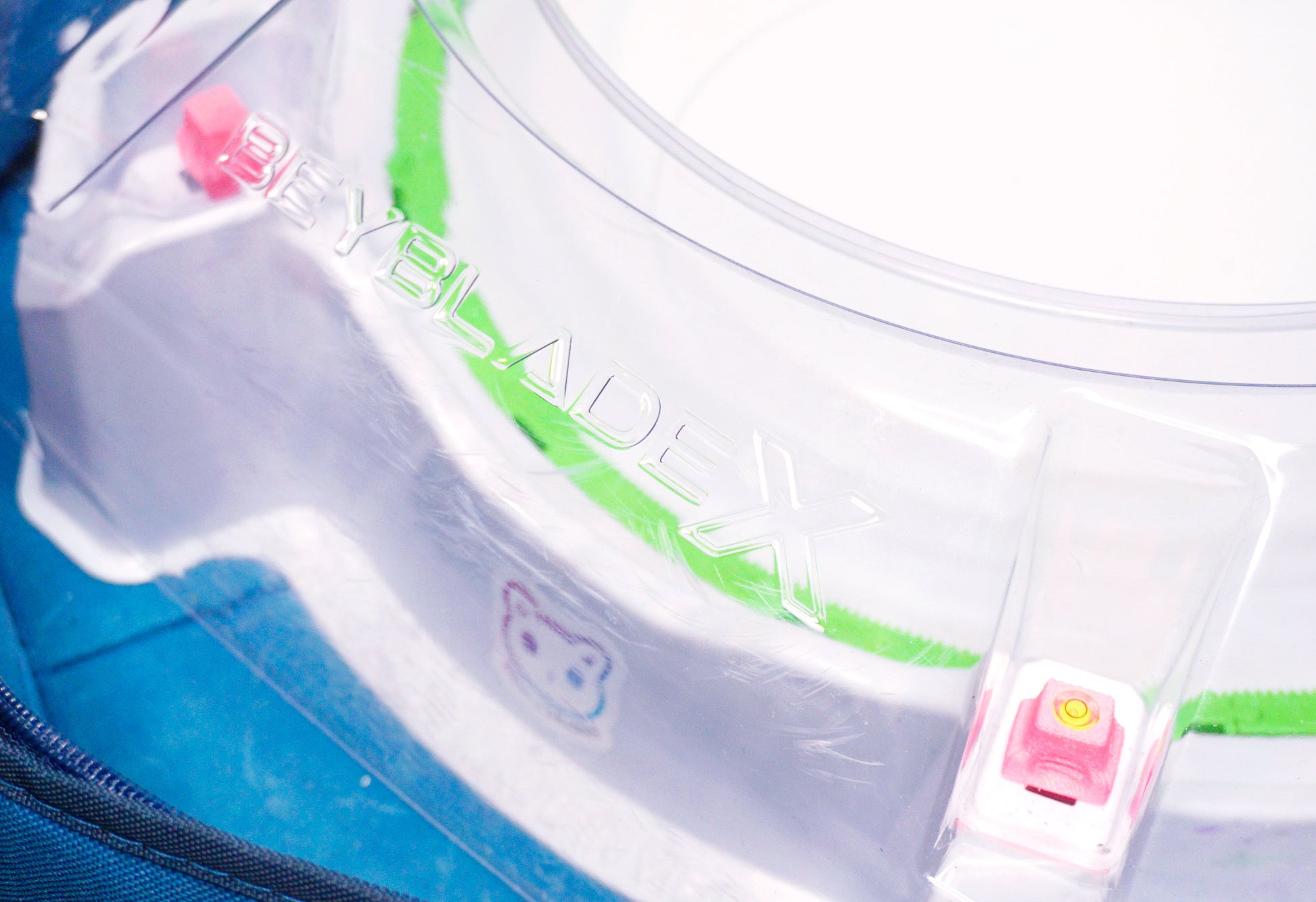 Stadium Level Locks in Pink on the Takara Tomy Beyblade X stadium. With the stadium in a blue case with a sticker for Momo's Models on the front.
