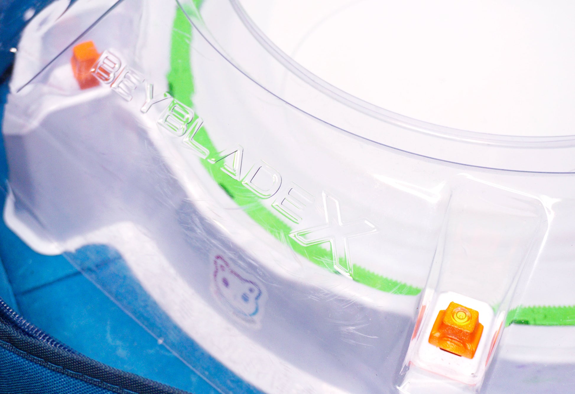 Stadium Level Locks in Orange on the Takara Tomy Beyblade X stadium. With the stadium in a blue case with a sticker for Momo's Models on the front.
