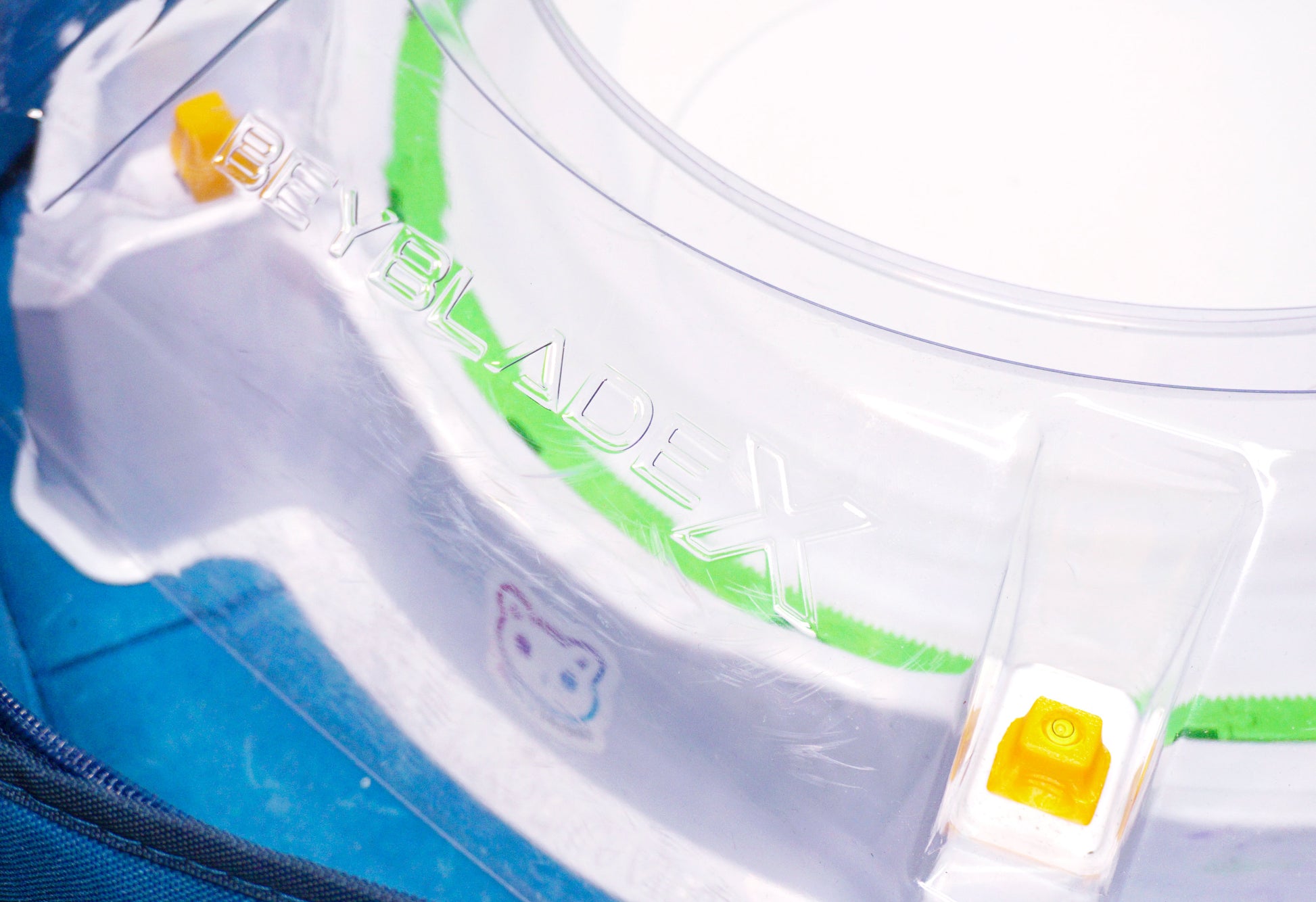 Stadium Level Locks in Yellow on the Takara Tomy Beyblade X stadium. With the stadium in a blue case with a sticker for Momo's Models on the front.