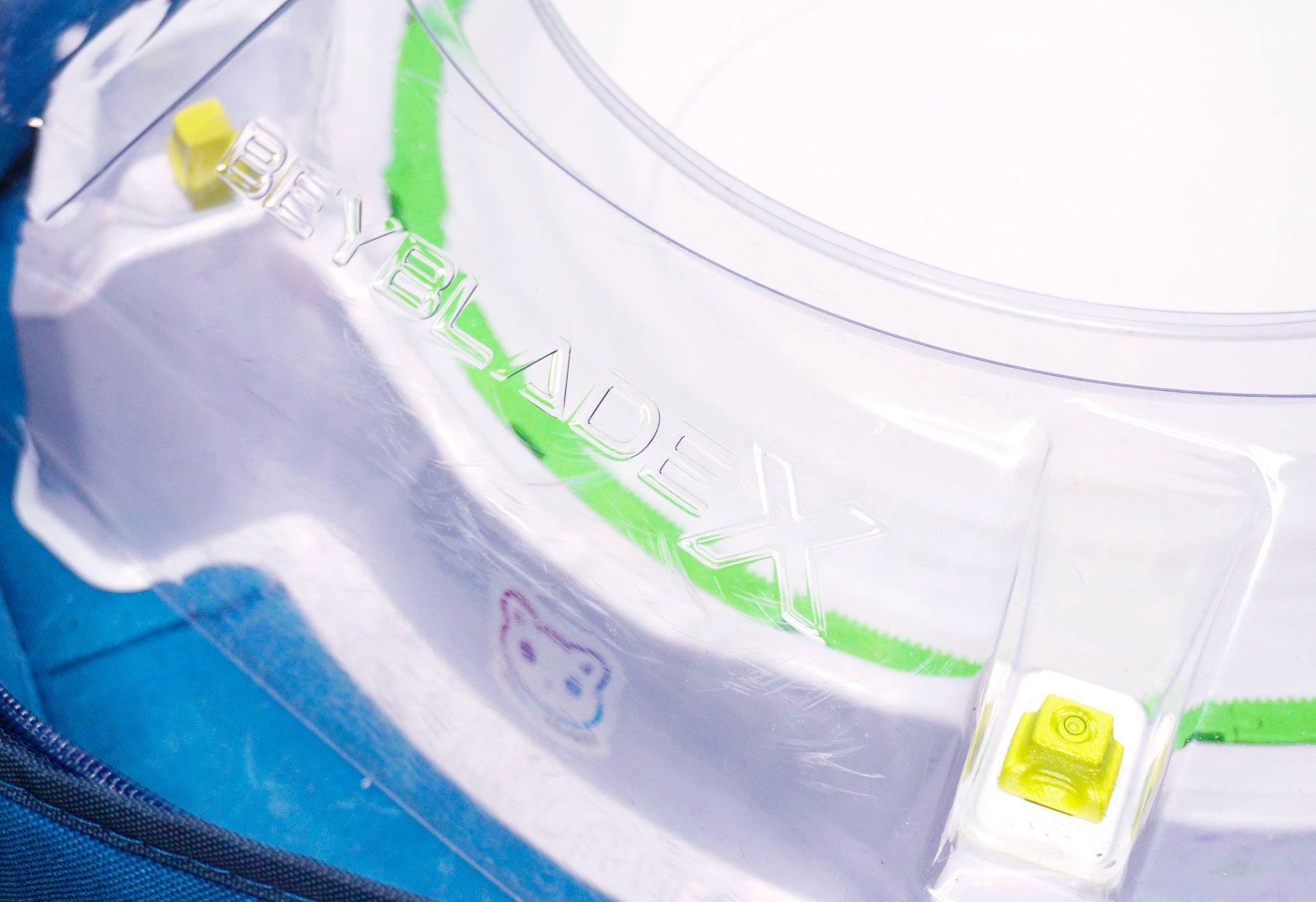 Stadium Level Locks in Lime on the Takara Tomy Beyblade X stadium. With the stadium in a blue case with a sticker for Momo's Models on the front.