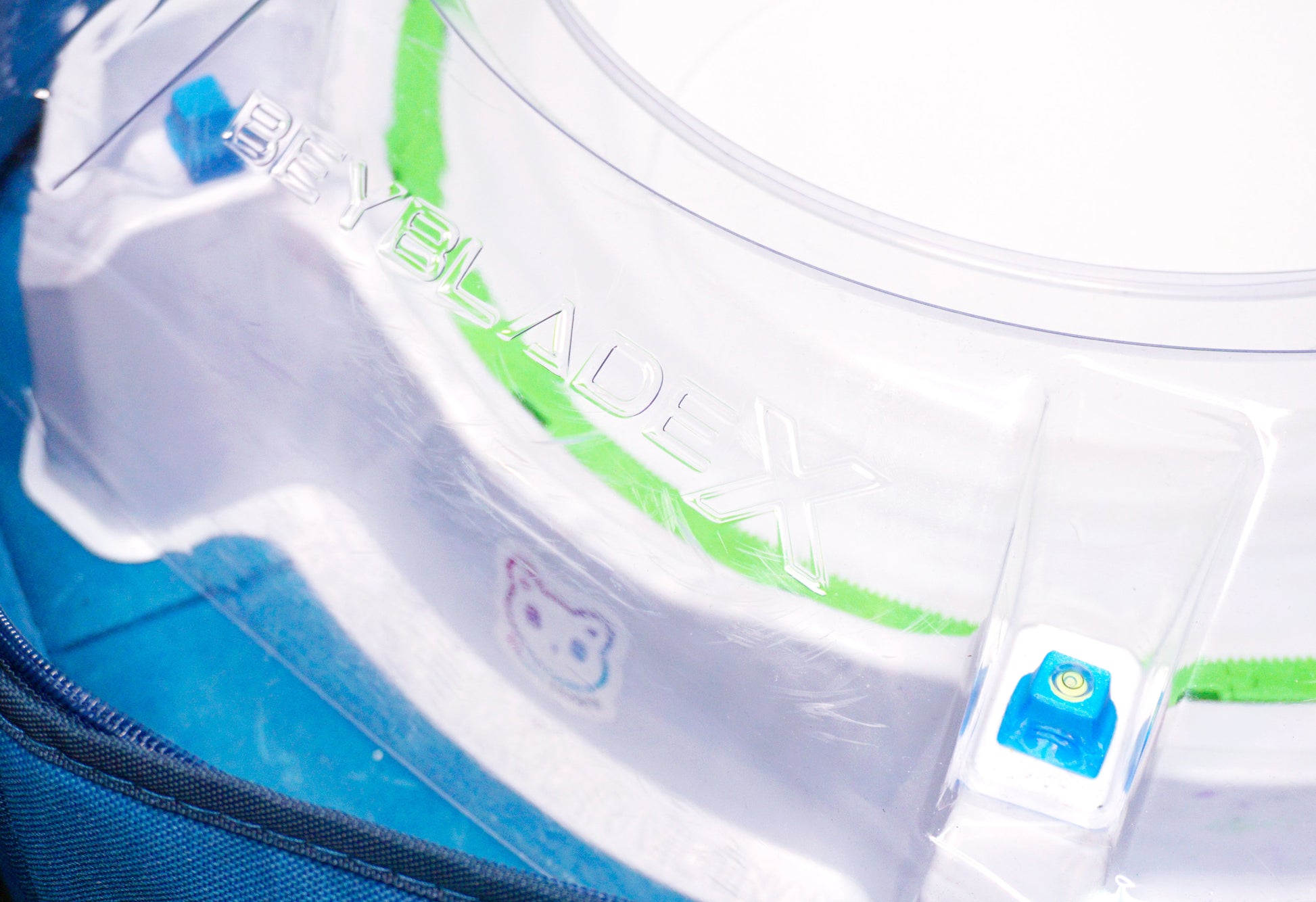 Stadium Level Locks in Sky Blue on the Takara Tomy Beyblade X stadium. With the stadium in a blue case with a sticker for Momo's Models on the front.