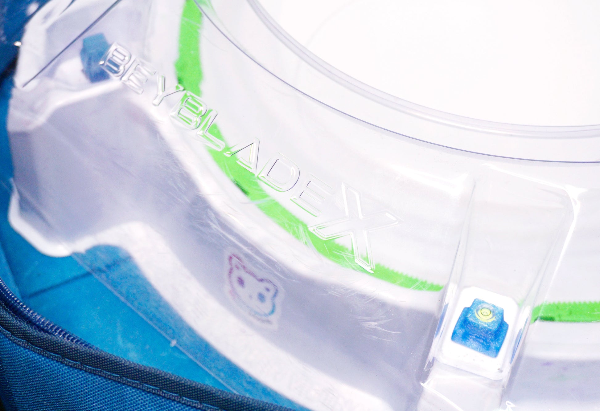 Stadium Level Locks in Blue on the Takara Tomy Beyblade X stadium. With the stadium in a blue case with a sticker for Momo's Models on the front.