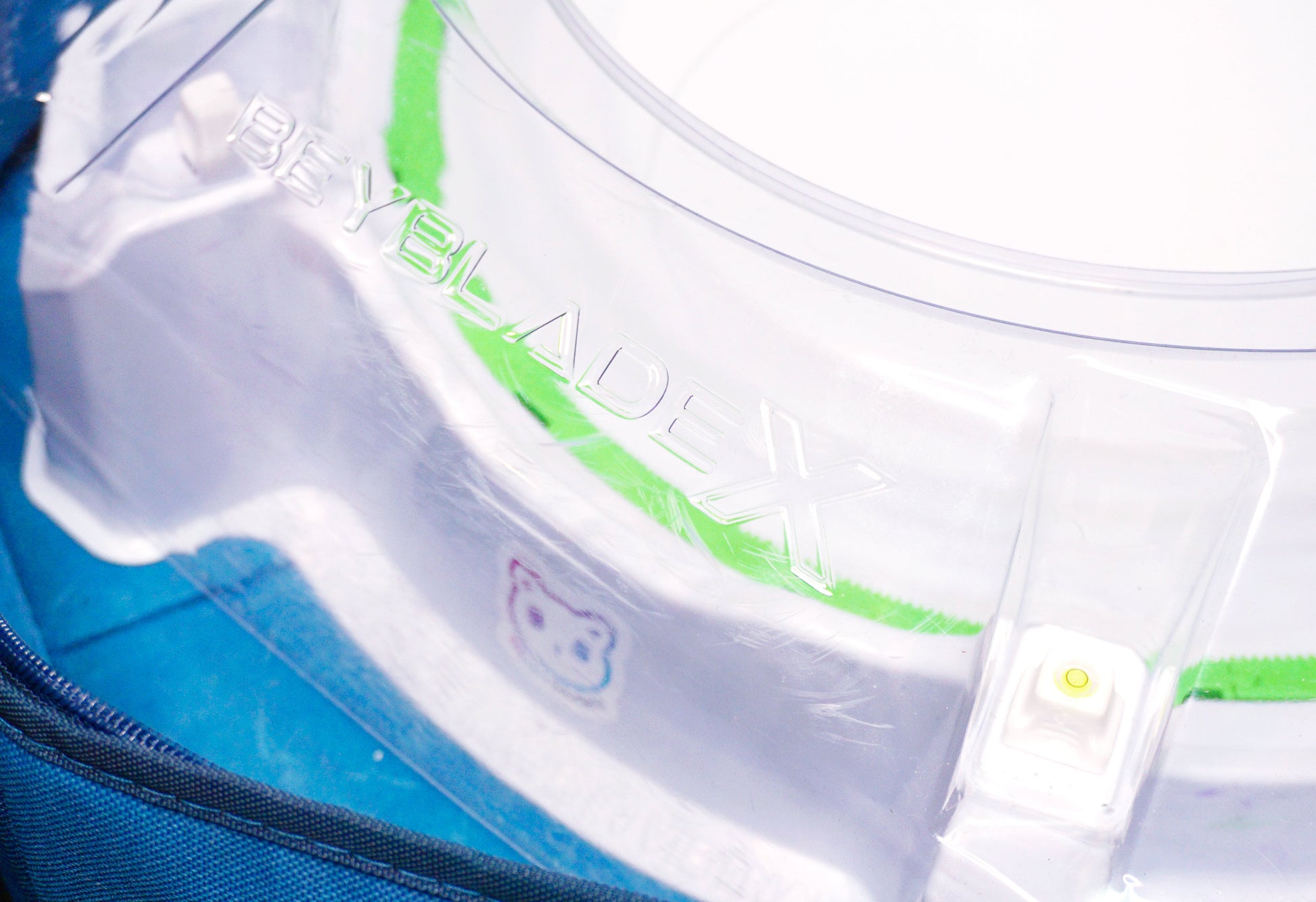 Stadium Level Locks in White on the Takara Tomy Beyblade X stadium. With the stadium in a blue case with a sticker for Momo's Models on the front.