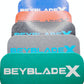 A stack of five Beyblade Pocket deck boxes in shades of green, black, red, gray, and blue. Each deck box features a geometric pattern and the text "BEYBLADE X" in white, black, or sky blue.