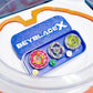 A blue container with the text "BEYBLADE X" holds three colorful spinning tops and small accessories. The set is inside a clear plastic arena with an orange rim.