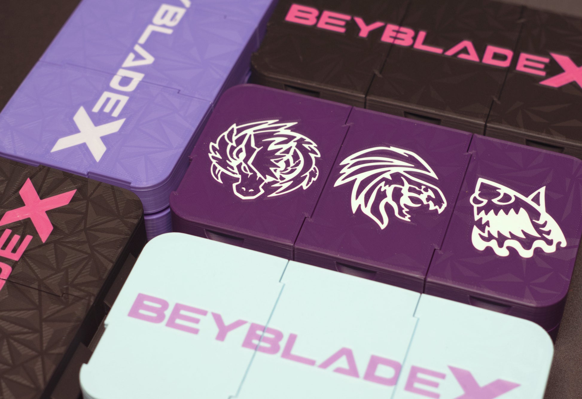 A variety of the Beyblade X Pocket Clam Shell Deck Boxes