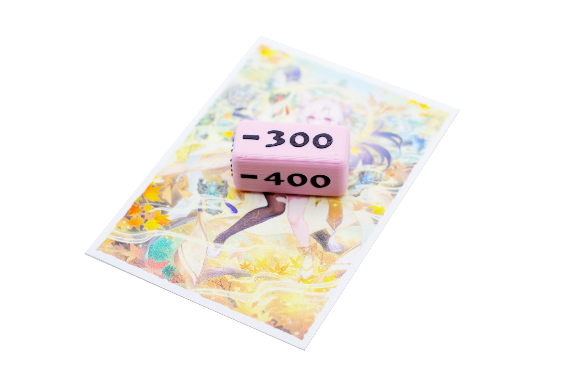 Showing a single negative 300 value Attack Marker on top of a card sleeve to compare sizes