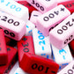 A pile of the Attack Increase/Decrease 100-400 Markers in various colors.