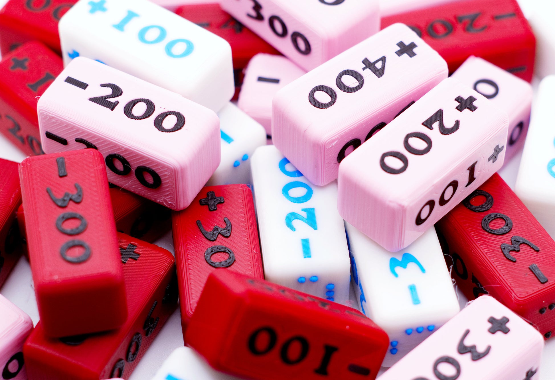 A pile of the Attack Increase/Decrease 100-400 Markers in various colors.