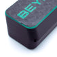 Close-up of a black rectangular electronic device with a textured top surface, featuring the partial brand name 'BEY' in bright green and a thin green accent line along the edge, set against a plain white background.