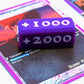 Attack Increase marker shown in purple and white on top of a Bleach Super Pre-Release card for Union Arena