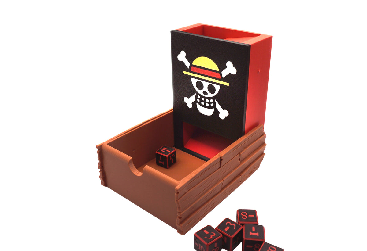 Angled pictured of the One Piece Dice Tower as it's opened up on a white background with red and black dice next to it and in the tray