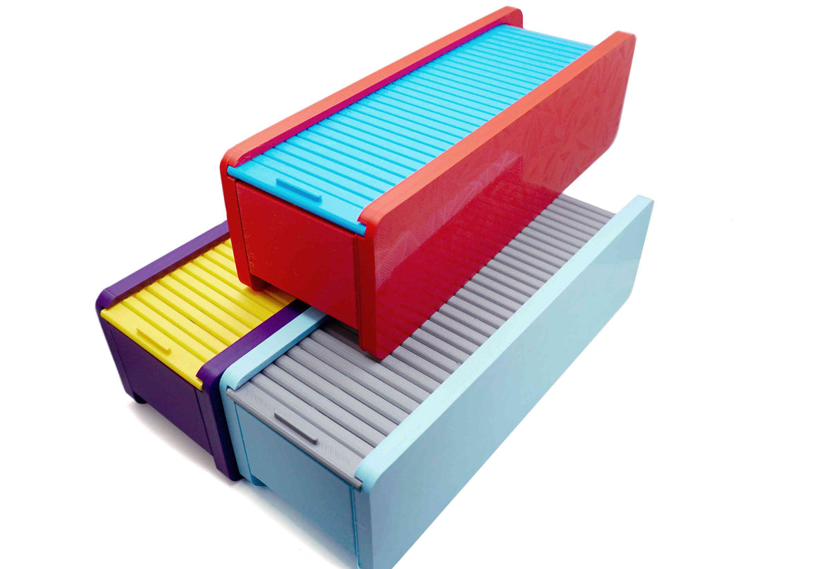 The Beyblade X Garage Door style deckbox from Momo's Models shown in purple and yellow color scheme, red and sky blue color scheme, and the glacier with grey color scheme. With everything against a white background