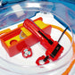 The Beyblade X Garage Door style deckbox from Momo's Models shown in the red and orange color scheme for good luck. Sitting inside the Takara Tomy stadium with a red ripcord launcher that has a red handle and red slip grip.