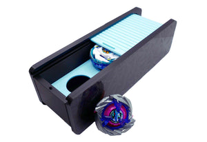 The Beyblade X Garage Door style deckbox from Momo's Models shown in black with glacier color scheme. Inside is the Pegasus Blast beyblade while outside sits the Shark Scale beyblade, with everything against a white background