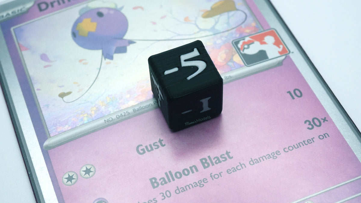 Black and white Mini Negative Dice with number -5 on a Pokémon trading card