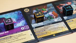Multiple Negative Dice shown in various color combos on top of multiple Lorcana TCG cards 