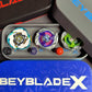 A collection of Beyblade X tops and storage cases. The tops feature various colors and designs, including green, purple, and white. The cases are black, gray, and blue, with the Beyblade X logo.