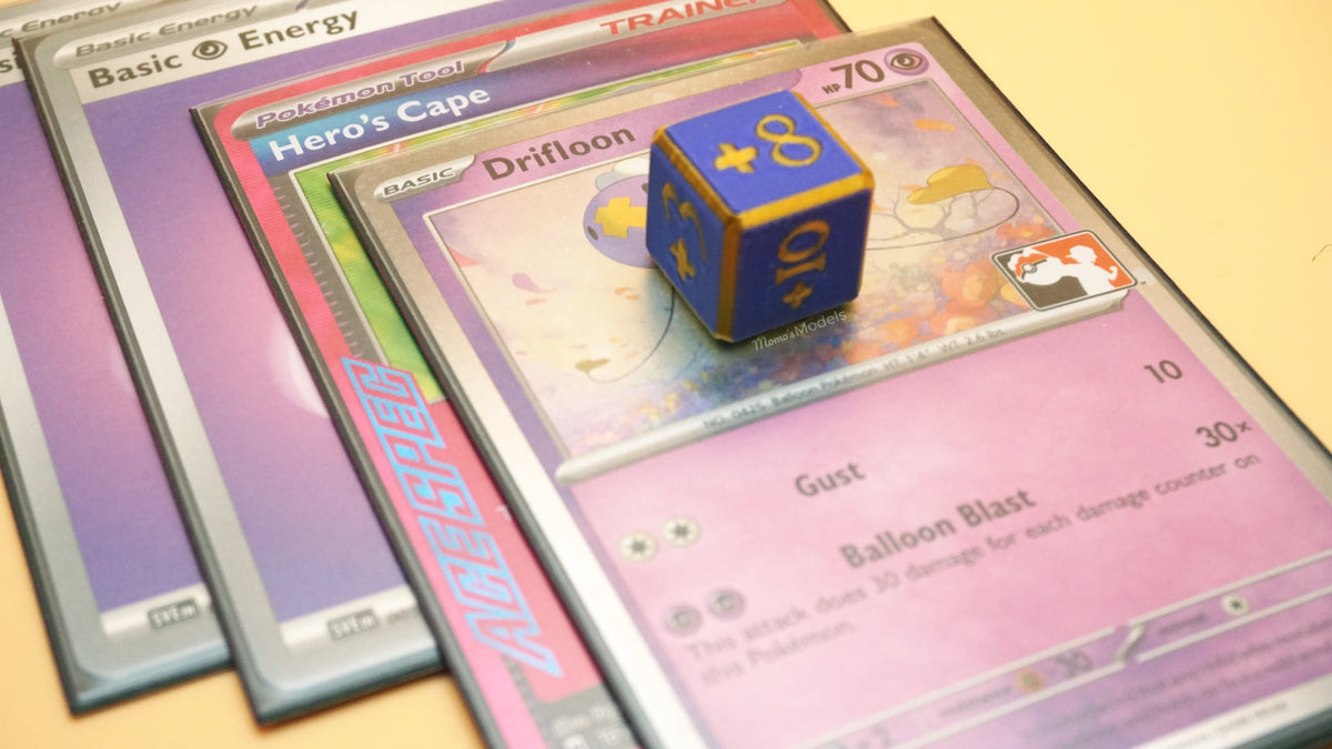 Positive Dice in lavender and gold colors with +8 shown on top of a Drifloon Pokemon card