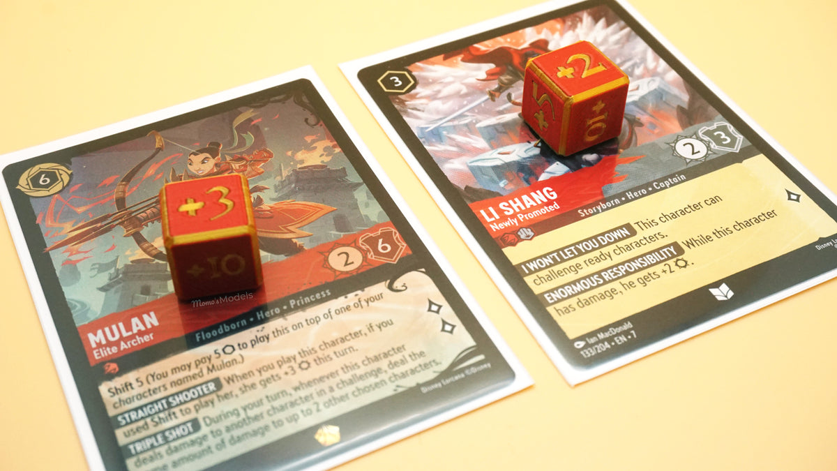 Multiple Positive Dice in red and gold shown on top of various red and red/steel Lorcana cards