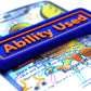 A blue Ability Used marker with orange text shown on top of a Shiny Pidgeot card from the Pokemon TCG.