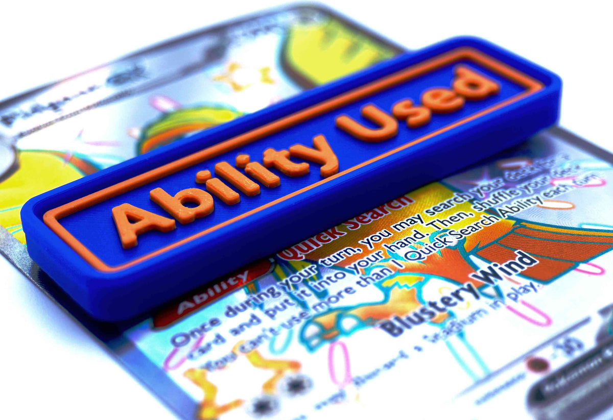 A blue Ability Used marker with orange text shown on top of a Shiny Pidgeot card from the Pokemon TCG.