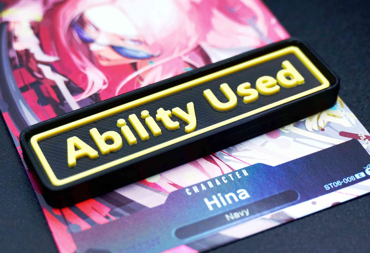 A black Ability Used marker with yellow text shown on top of a Hina card from the One Piece TCG.